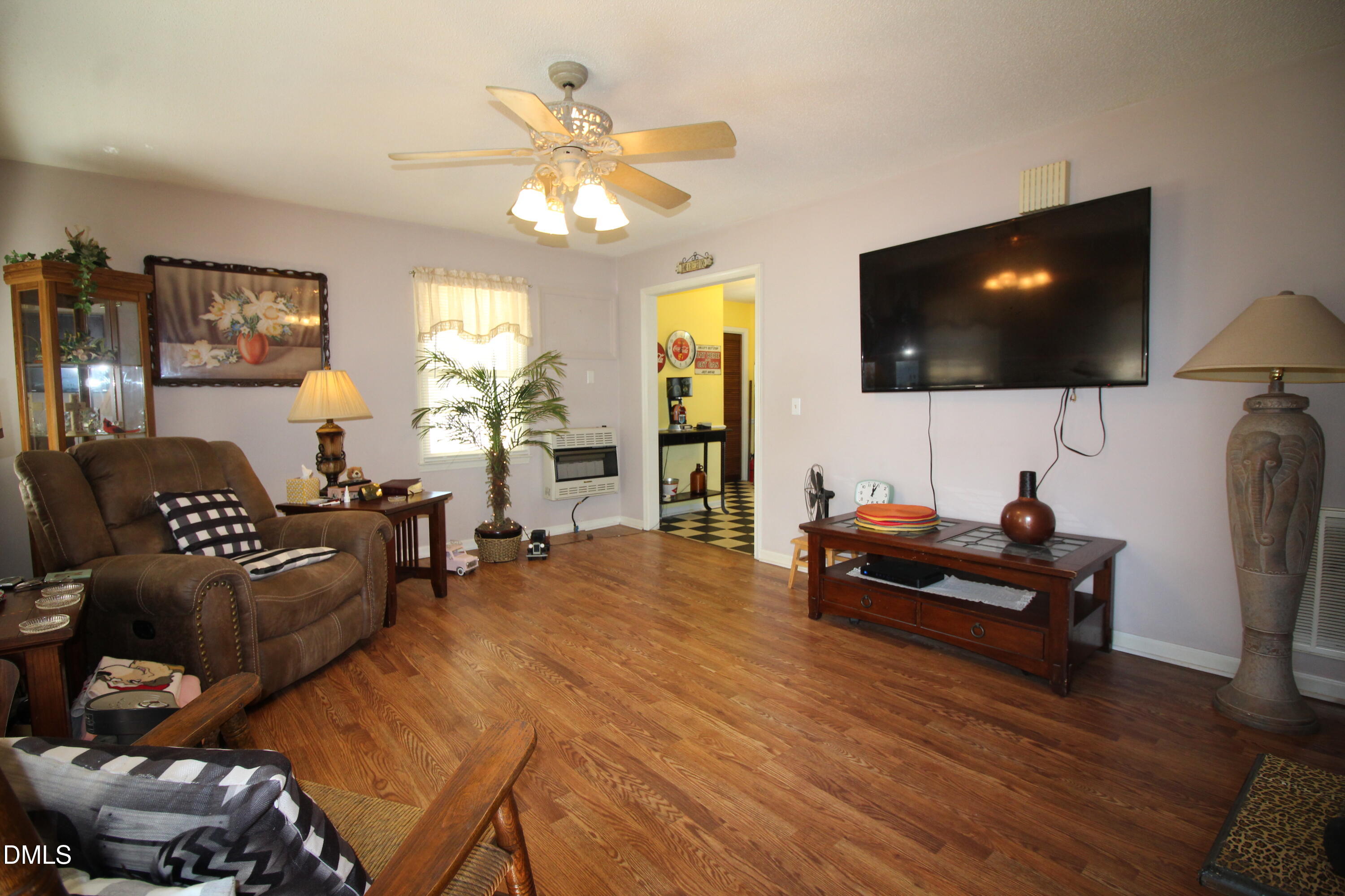 56 Ash Street Coats, NC 27521 - Photo 21 of 28 a living room with furniture and a flat screen tv