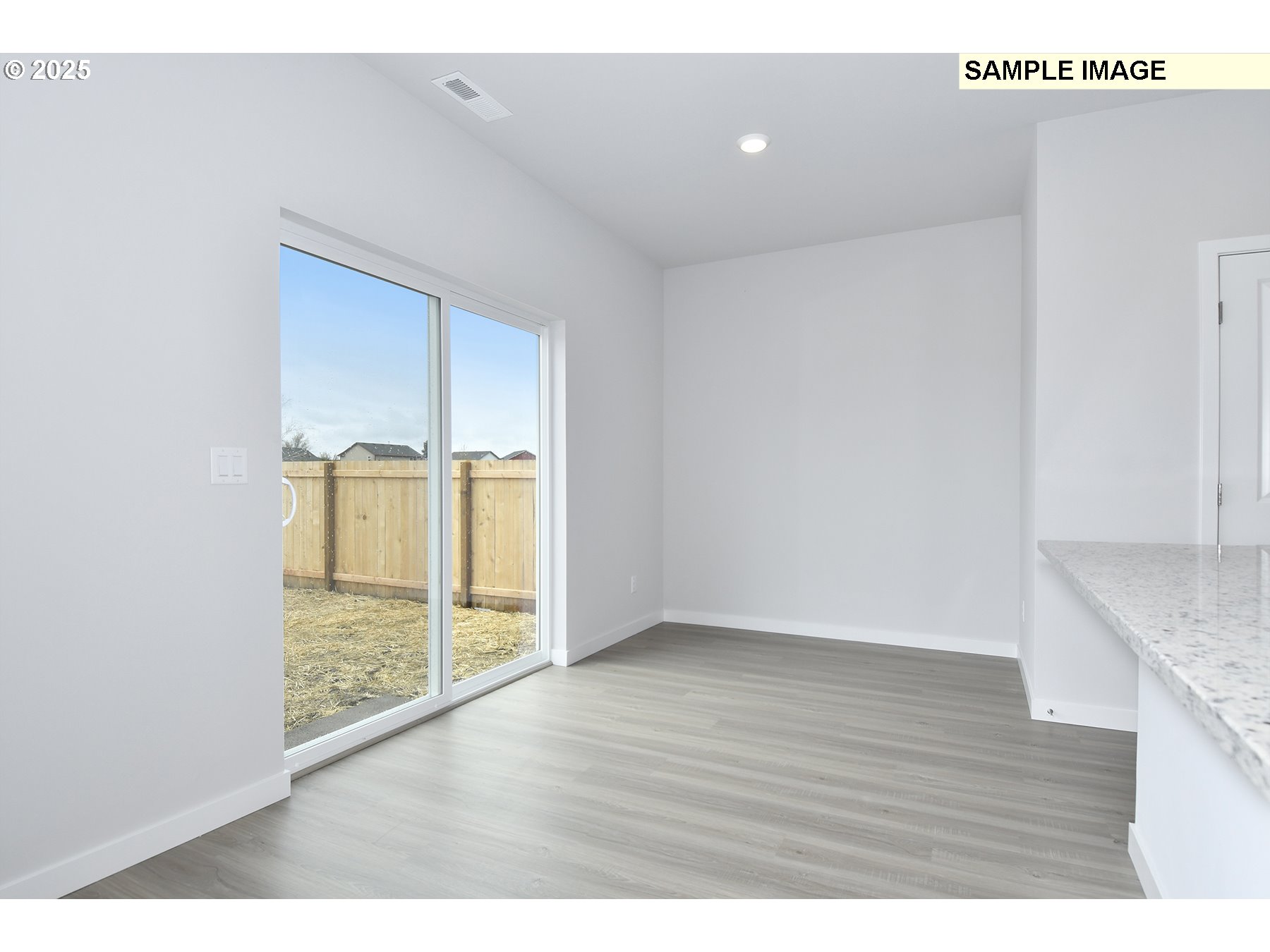 1122 Parkside Avenue Woodburn, OR 97071 - Photo 11 of 22 a view of an empty room with wooden floor and a window