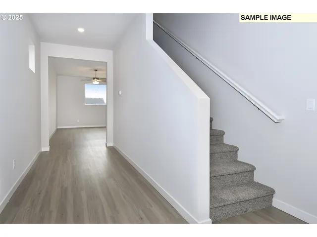 a view of an entryway with wooden floor
