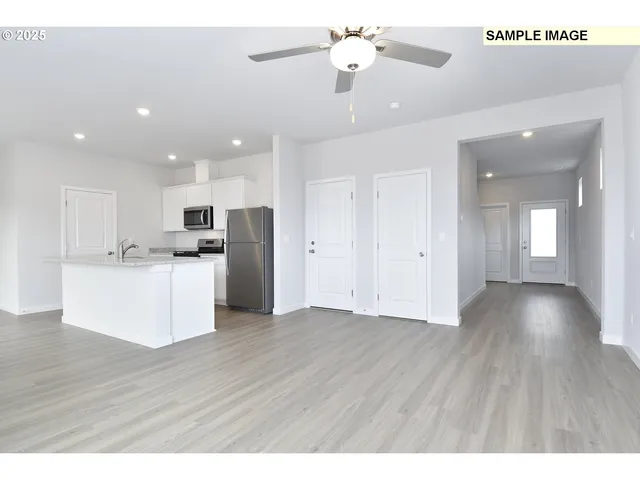 a view of a kitchen with wooden floor and a kitchen