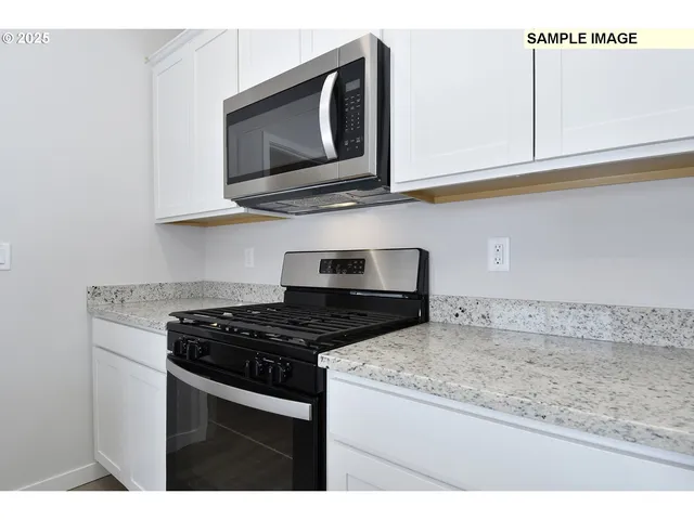 a kitchen with granite countertop cabinets and steel stainless steel appliances