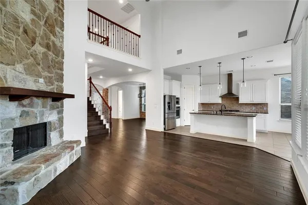a view of an entryway with kitchen and fireplace
