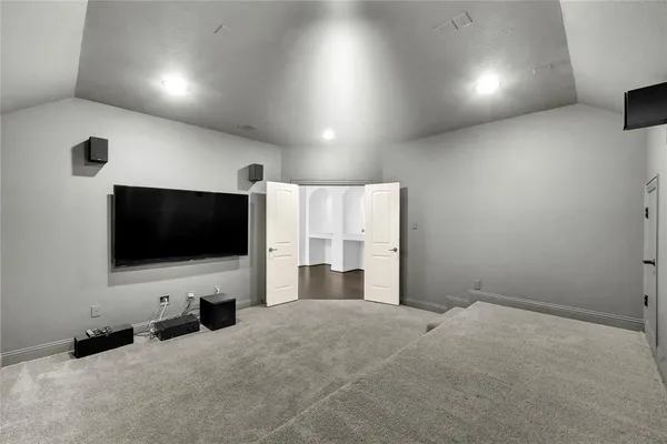 a view of a livingroom with furniture and a flat screen tv