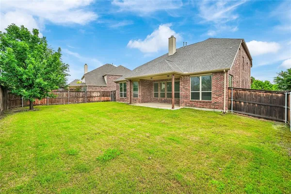 a front view of a house with a garden and yard