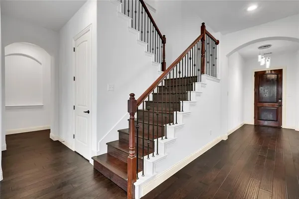 a view of entryway and hall with wooden floor