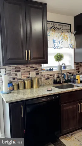 a kitchen with stainless steel appliances granite countertop a sink and a wooden cabinets