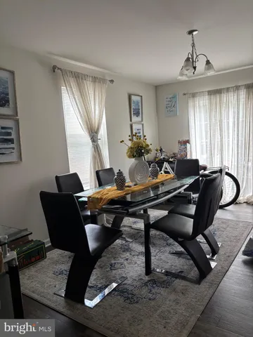 a living room with furniture a window and a chandelier