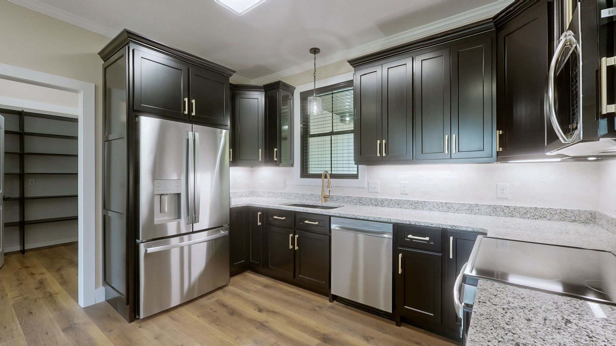 865 Alman Cemetery Road Paris, TN 38242 - Photo 8 of 41 a kitchen with granite countertop stainless steel appliances and refrigerator