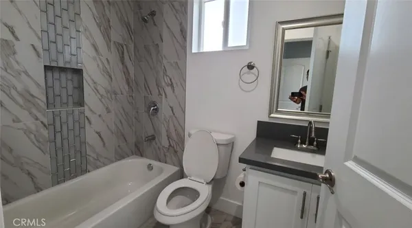 a bathroom with a toilet a sink and bathtub