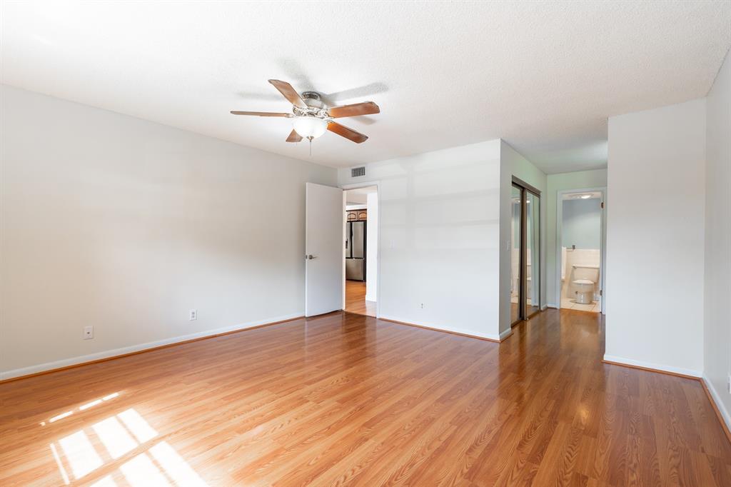 22605 Southwest 66th Avenue, Unit 102 Boca Raton, FL 33428 - Photo 20 of 27 a view of empty room with wooden floor and fan