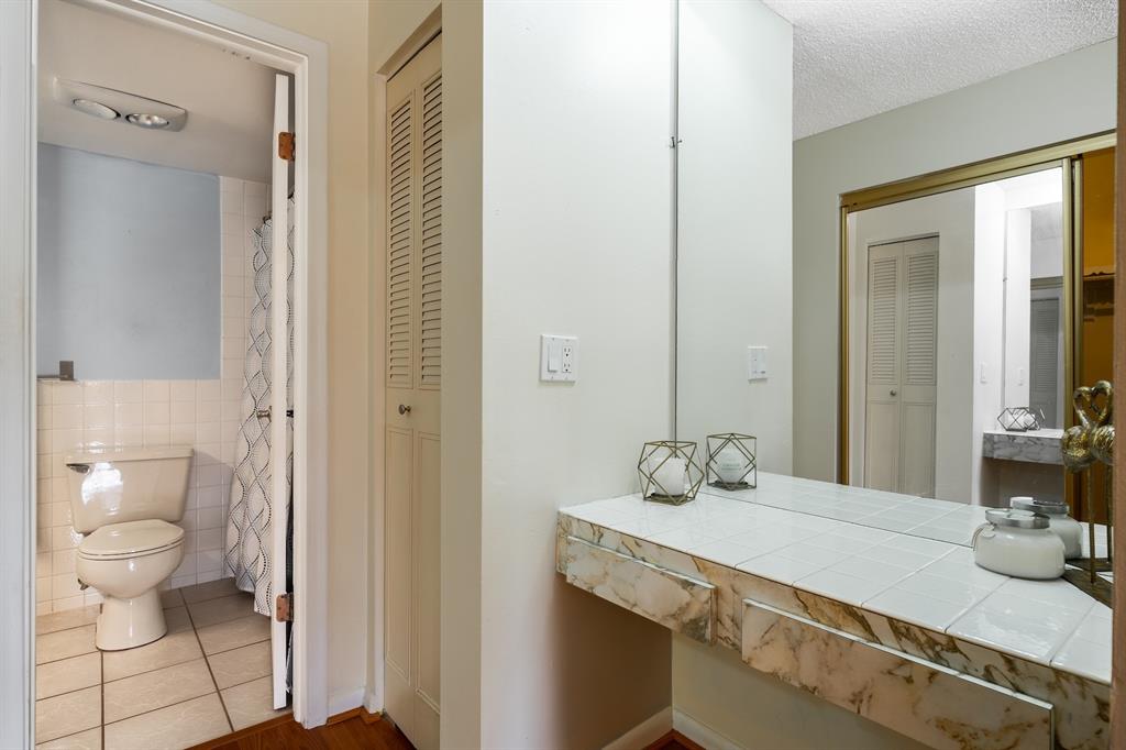 22605 Southwest 66th Avenue, Unit 102 Boca Raton, FL 33428 - Photo 21 of 27 a bathroom with a sink and a mirror