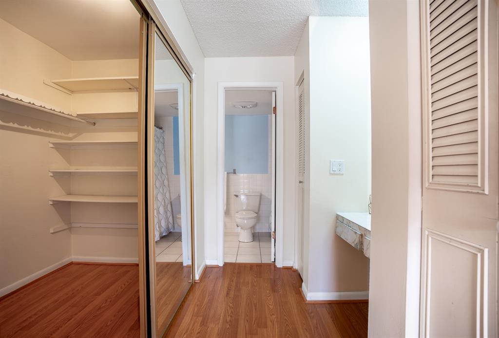 22605 Southwest 66th Avenue, Unit 102 Boca Raton, FL 33428 - Photo 9 of 27 a view of a hallway with wooden floor and staircase