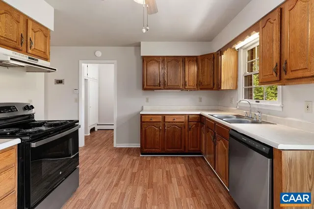 a bathroom with a granite countertop toilet a sink and a bathtub