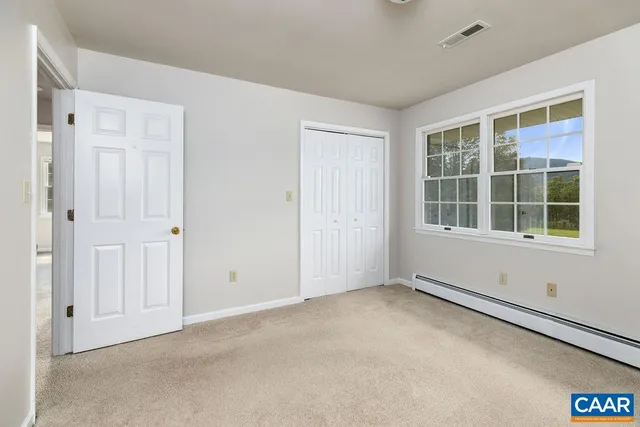 a view of a yard with a table and chairs under an umbrella