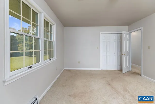 a view of a big yard with mountains in the background