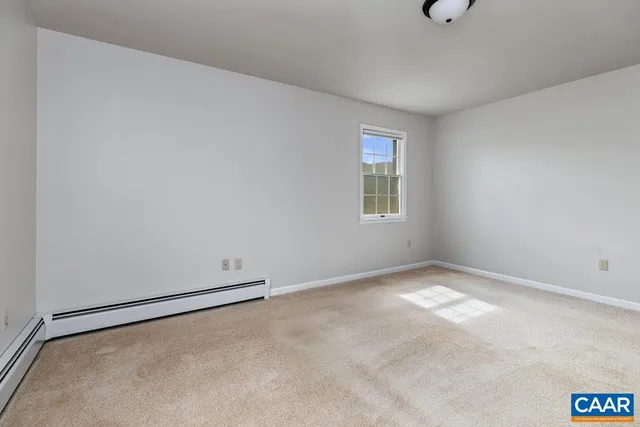 a view of a lake with a trees in the background