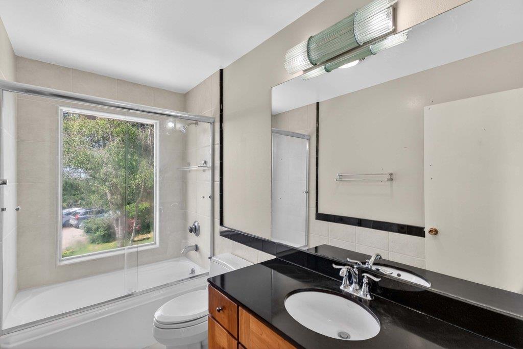 505 Hidden Valley Road Watsonville, CA 95076 - Photo 39 of 72 a bathroom with a granite countertop sink toilet a large mirror and shower