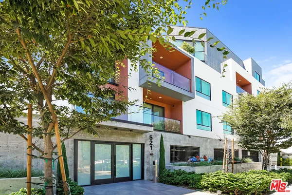 a front view of a building with a garden