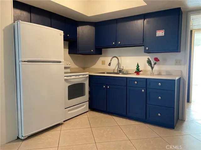 a kitchen with stainless steel appliances a sink and a refrigerator
