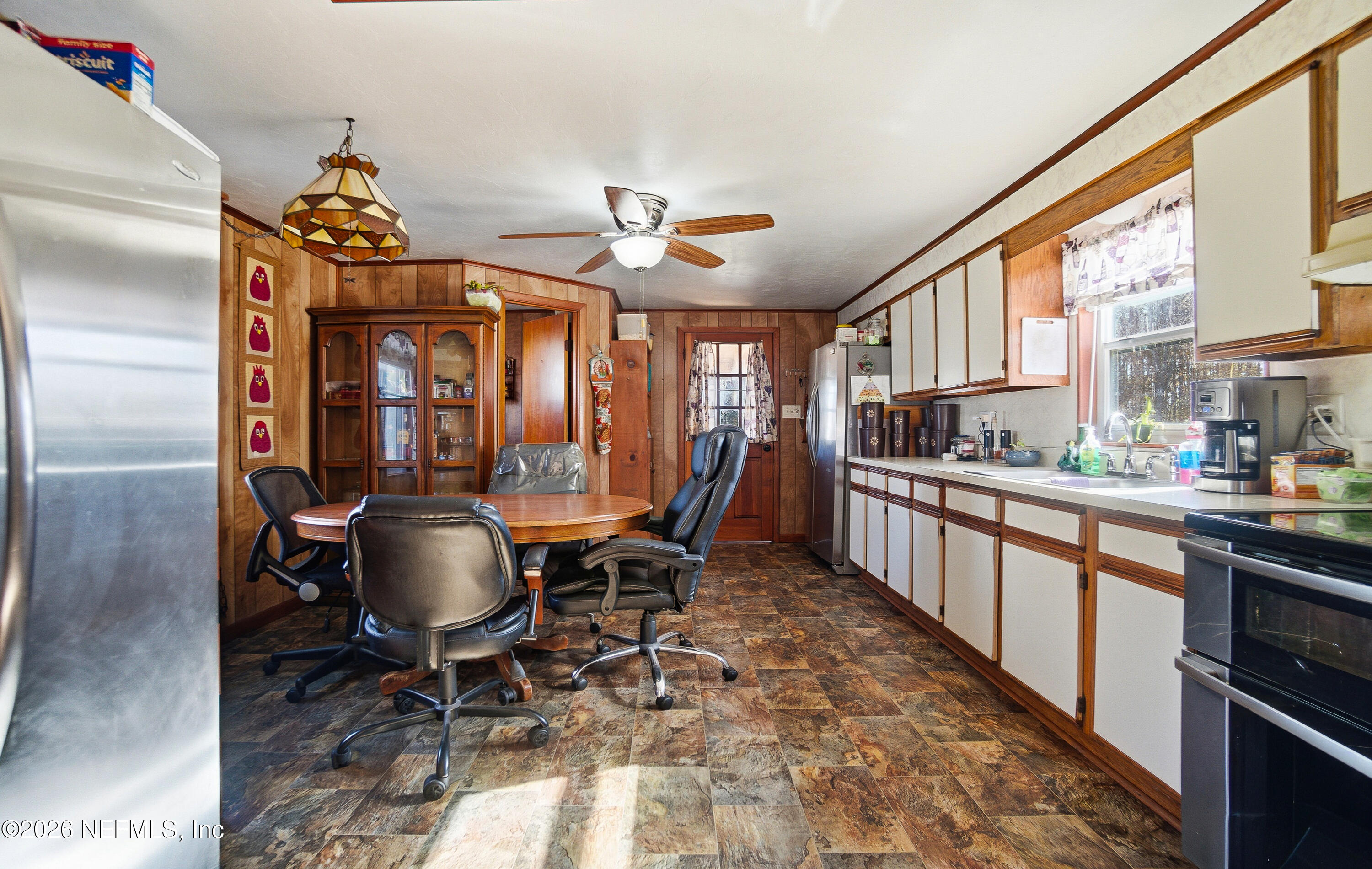 18273 Highway 16 Starke, FL 32091 - Photo 11 of 42 a kitchen with stainless steel appliances a dining table and chairs