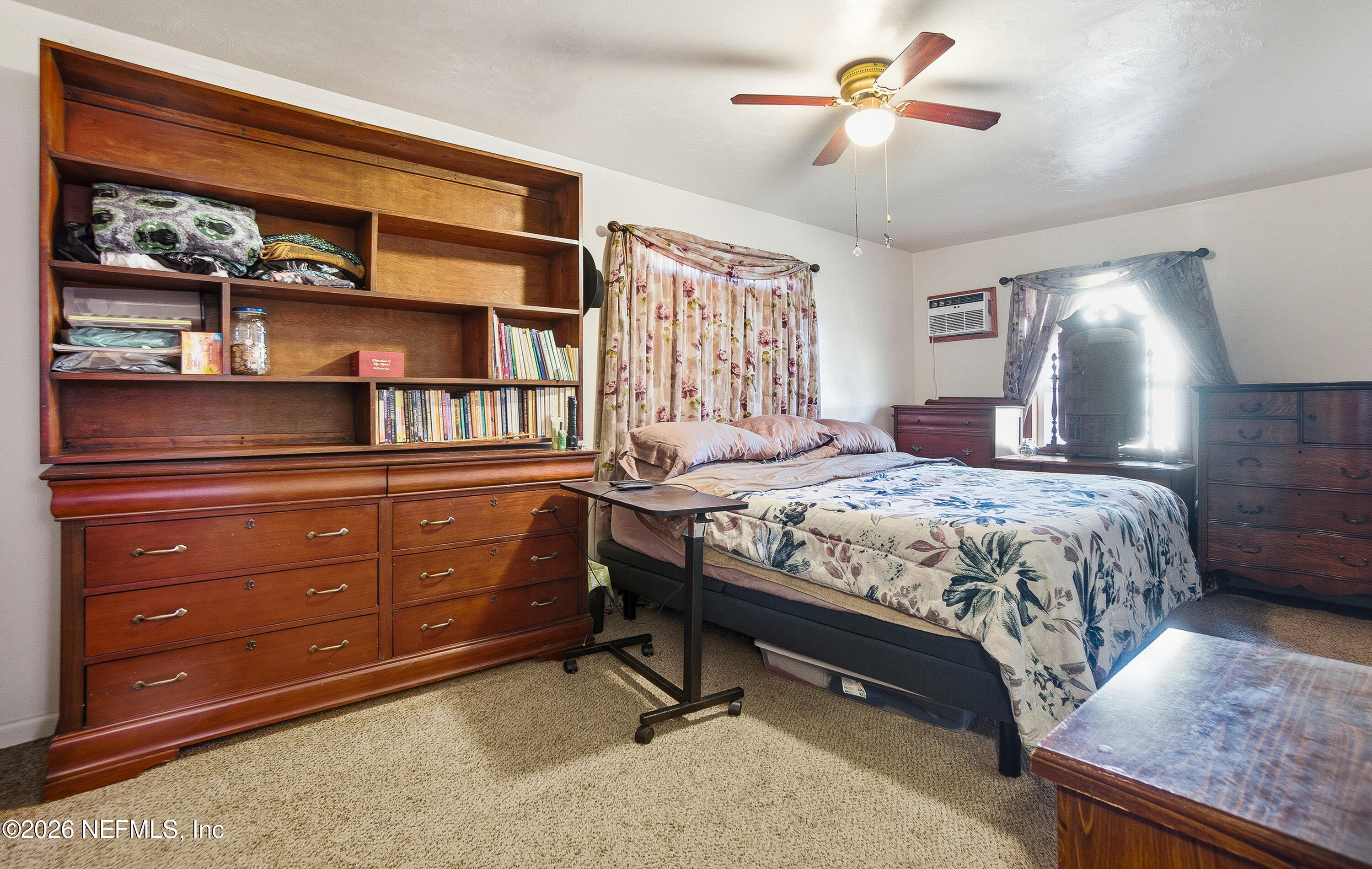 18273 Highway 16 Starke, FL 32091 - Photo 14 of 42 a bedroom with a bed and a chandelier