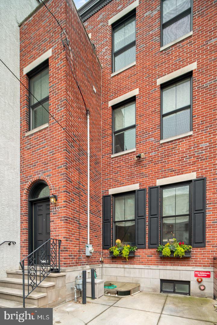 a front view of a brick building with many windows