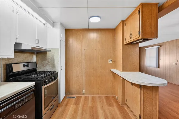 a stove top oven sitting inside of a kitchen