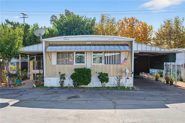 front view of house with potted plants