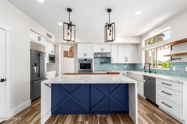 a view of a kitchen with wooden floor and a kitchen