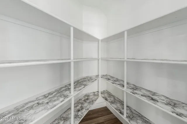 an empty room with a empty space and windows