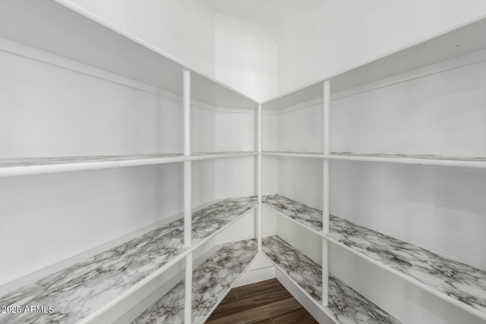 1874 West San Angelo Street Gilbert, AZ 85233 - Photo 17 of 55 a walk in closet with wooden floor