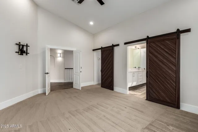 a spacious bathroom with a double vanity sink and mirror