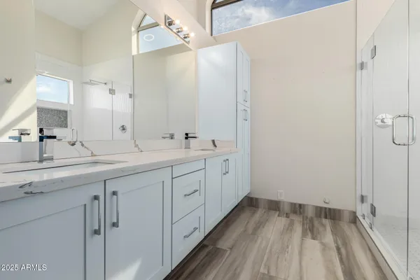 a view of an empty room and chandelier fan