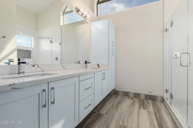 a view of an empty room and chandelier fan