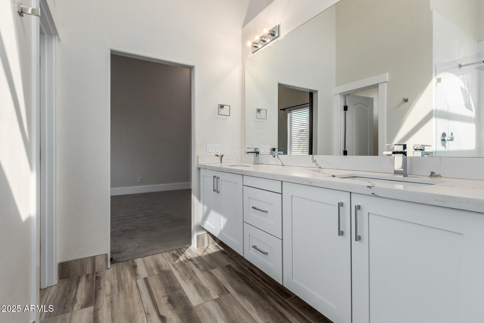 1874 West San Angelo Street Gilbert, AZ 85233 - Photo 24 of 55 a spacious bathroom with a double vanity sink and mirror