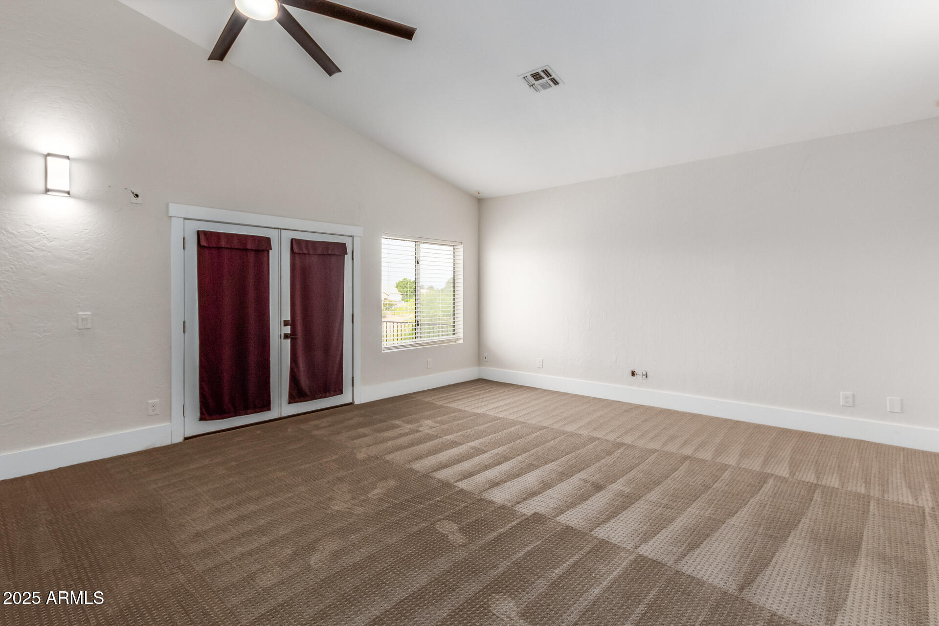 1874 West San Angelo Street Gilbert, AZ 85233 - Photo 27 of 55 an empty room with windows and fan