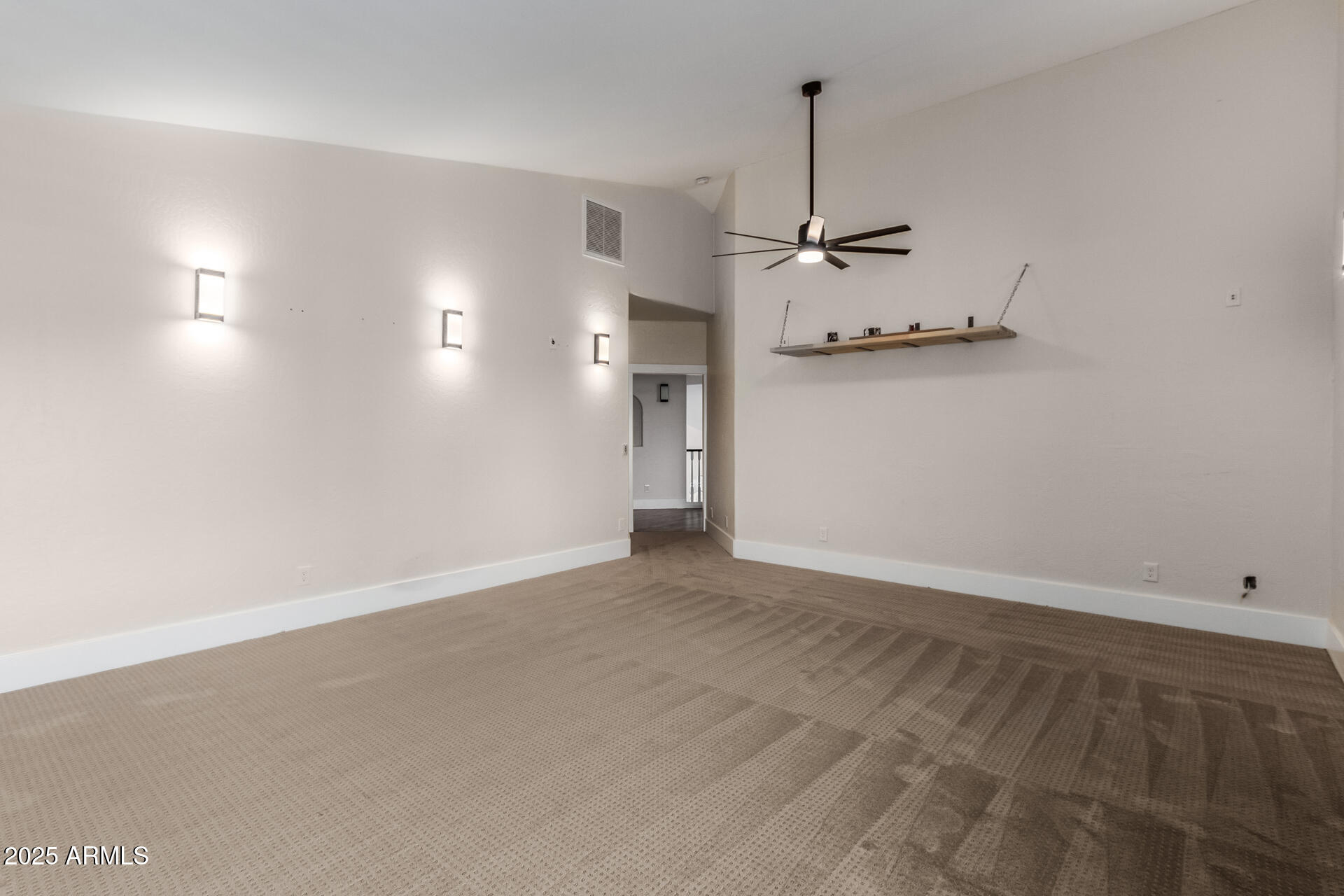 1874 West San Angelo Street Gilbert, AZ 85233 - Photo 29 of 55 an empty room with a ceiling fan and a window