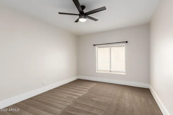 a view of empty room with ceiling fan