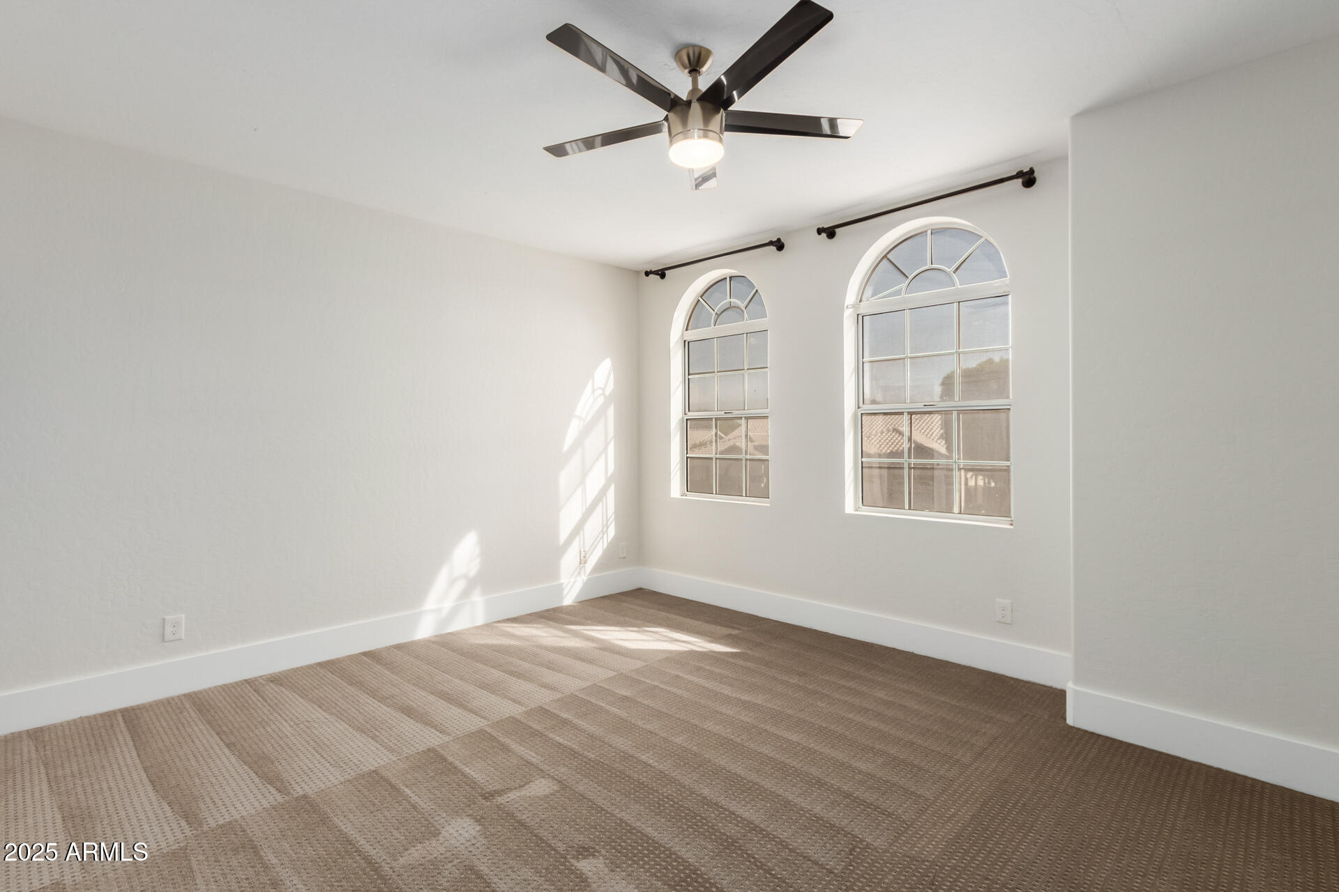 1874 West San Angelo Street Gilbert, AZ 85233 - Photo 36 of 55 an empty room with wooden floor fan and windows