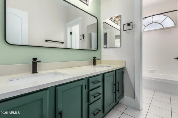 a kitchen with granite countertop a refrigerator and a sink