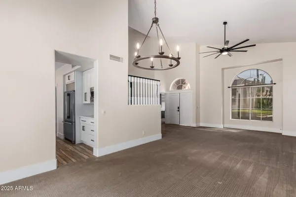 a view of an empty room with a fireplace and a window