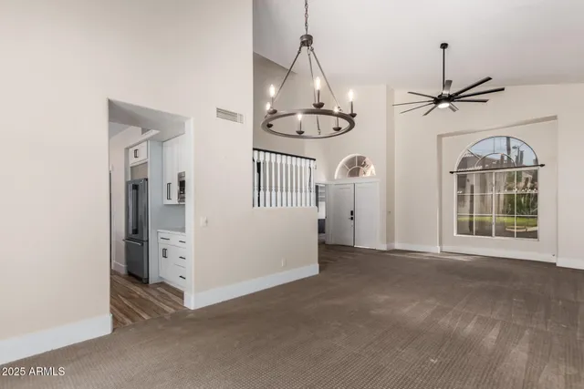 a view of an empty room with a fireplace and a window