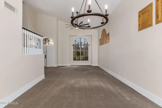 wooden floor fireplace and windows in an empty room