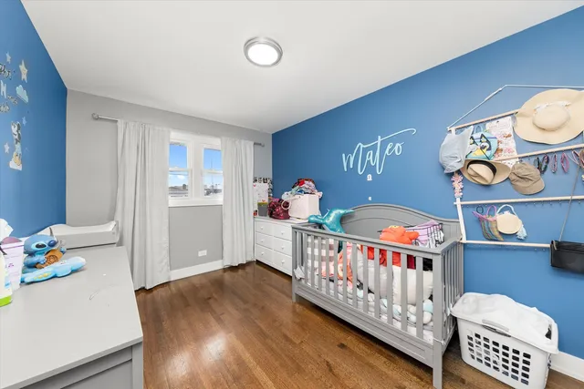 a bedroom with furniture and baby crib