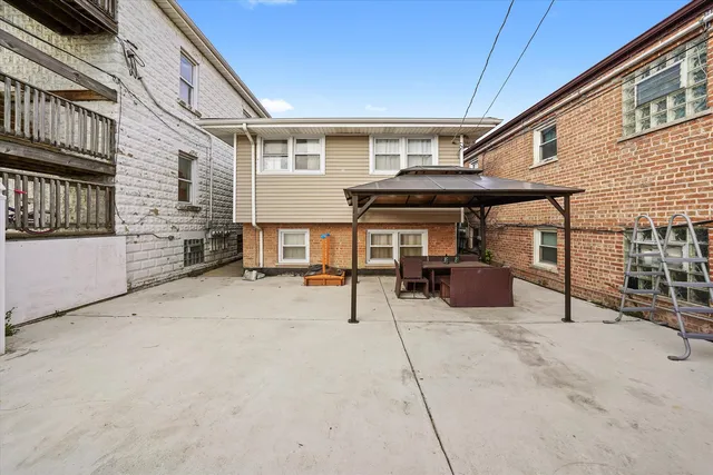 a view of a house with floor to ceiling windows and a table