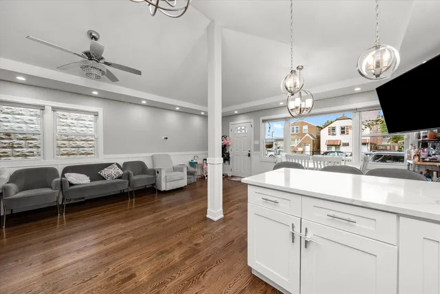 a living room with furniture a chandelier and a flat screen tv