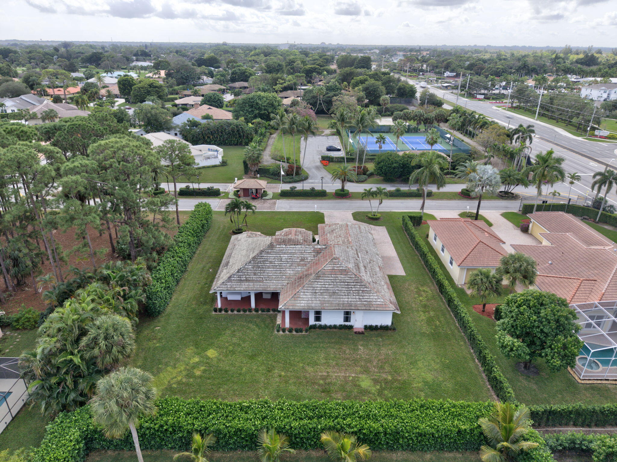 an aerial view of a house with a garden and lake view