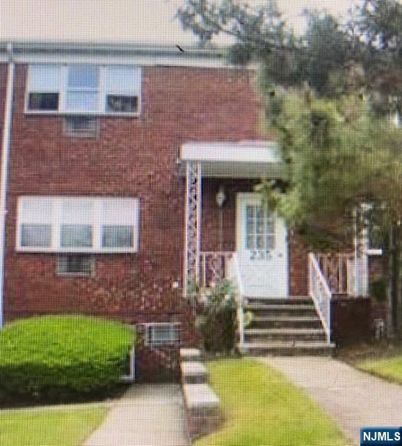 235 Mary Street, Unit 1 Hackensack, NJ 07601 - Photo 1 of 4 a front view of a house with a garden