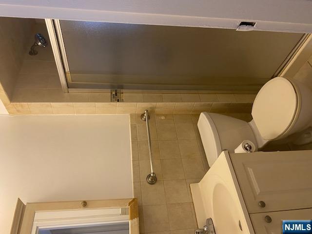 235 Mary Street, Unit 1 Hackensack, NJ 07601 - Photo 2 of 4 a white toilet sitting next to a bathroom sink