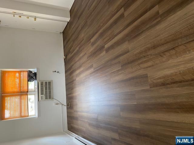 235 Mary Street, Unit 1 Hackensack, NJ 07601 - Photo 3 of 4 a view of empty room with wooden floor and fan